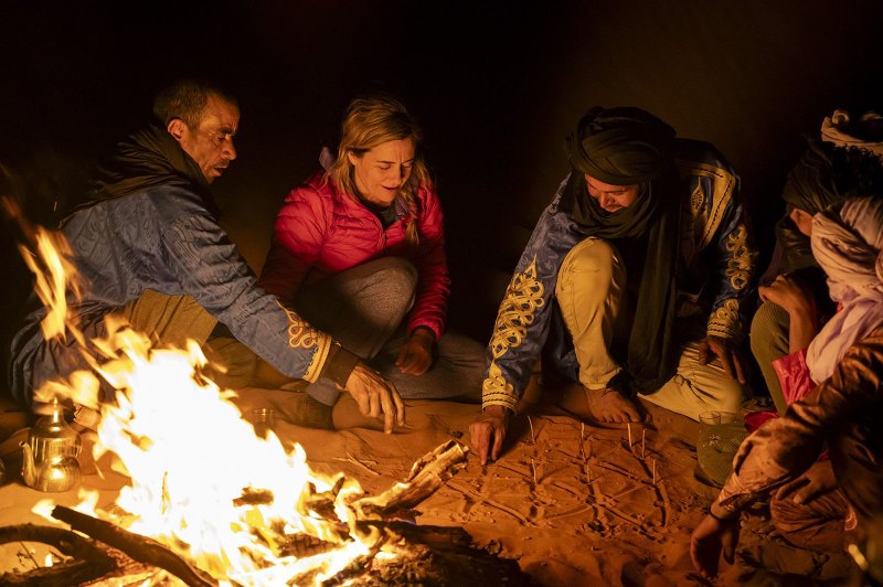 Campfire evening gathering at desert camp in M'Hamid Morocco