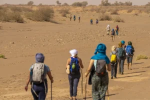 Sahara walking tour across dunes in Morocco during the mild autumn season